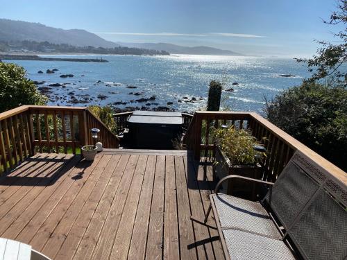 a wooden deck with a view of the water at Mermaid's Muse Bed and Breakfast in Brookings
