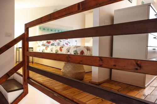 a room with a couch on a wooden shelf at DomoMea - Villetta Poseidone in Costa Rei