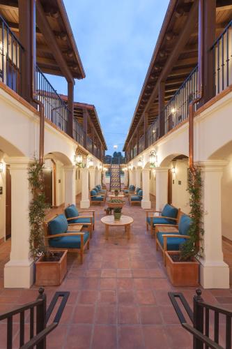 a courtyard with chairs and tables in a building at La Playa Inn Santa Barbara in Santa Barbara