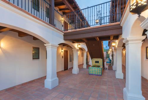 a large building with a walkway leading to a stairway at La Playa Inn Santa Barbara in Santa Barbara