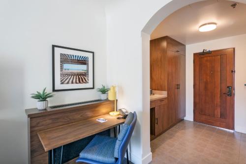 a home office with a desk and a blue chair at La Playa Inn Santa Barbara in Santa Barbara