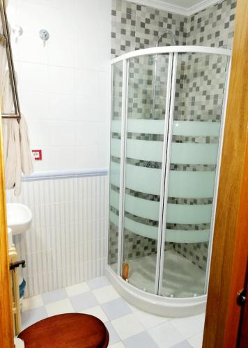 a shower with a glass door in a bathroom at ALBOR II in Gijón