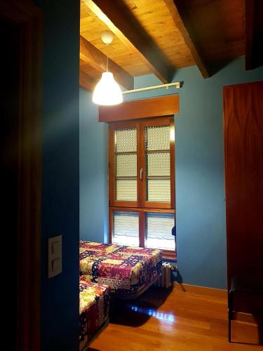 a room with a window and a bed in it at ALBOR II in Gijón