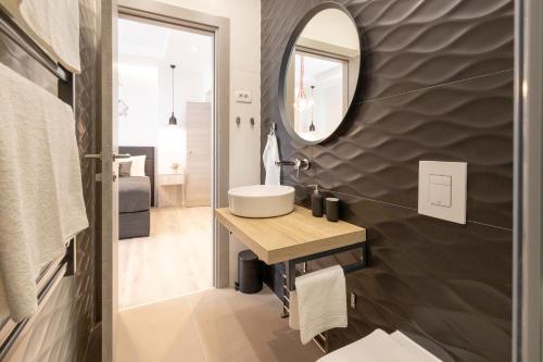 a bathroom with a sink and a mirror at Sweet Dreams-Old Town in Split