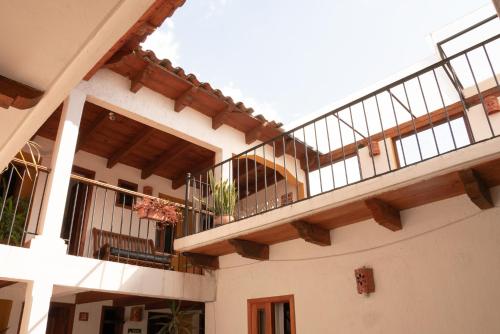 a building with a balcony with a staircase at Hotel Casa Margarita in San Cristóbal de Las Casas