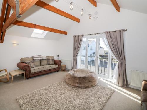 a living room with a couch and a large window at Bay View in Holyhead