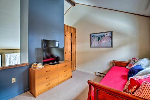 a bedroom with a bed and a flat screen tv at Loon Mountain Condo with Pool and Game Room Access! in Lincoln