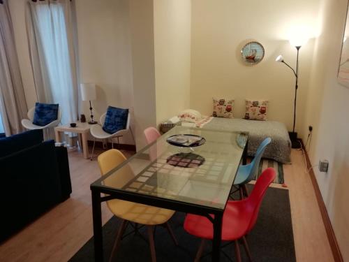 a living room with a glass table and chairs at Sailorman House in Aveiro