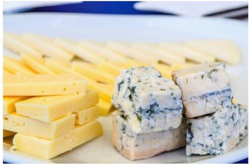 a plate of cheese and crackers on a table at ALBOR II in Gijón
