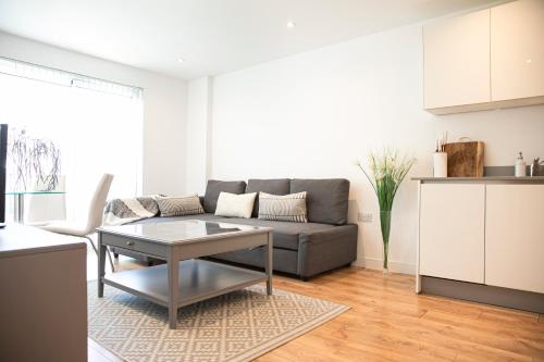 a living room with a couch and a table at Sunshine Place in Enfield