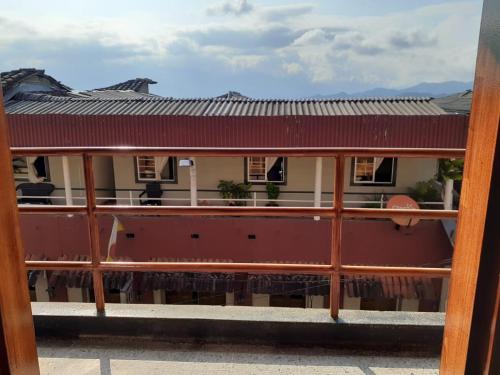 a view of a house from a balcony at Hotel Mirador Santana in Anserma