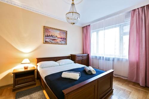 a bedroom with a bed with two towels on it at MaxRealty24 Begovaya 28 in Moscow