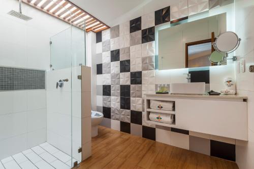 a bathroom with a shower and a toilet and a mirror at FCH Hotel Expo Adults only in Guadalajara