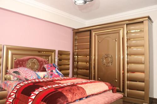 a bedroom with a bed and a large closet at Amir flat -ميامي- عائلات فقط in Alexandria