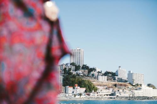 a view of a city from the water at Romance za Kado in Atami