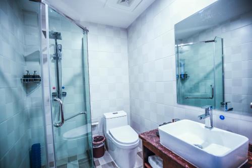 a bathroom with a shower and a sink and a toilet at Dunhuang Season Boutique Hotel in Dunhuang