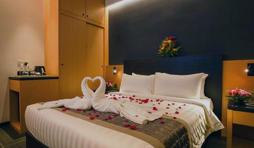 a bed with two swans made out of hearts at TSR Seafront Hotel in Port Dickson