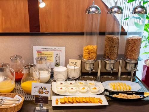 a table with food and other food items on it at Okayama International Hotel in Okayama