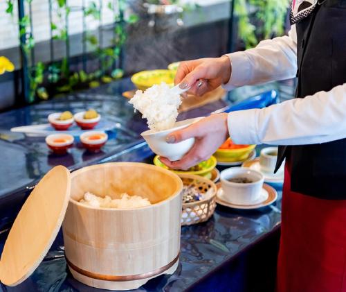 a person is preparing food on a counter at Okayama International Hotel in Okayama