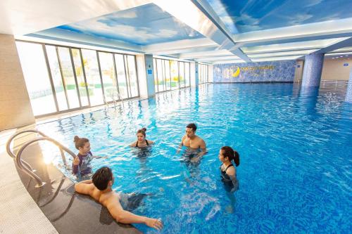 a group of people in a swimming pool at Duc Huy Grand Hotel in Lao Cai