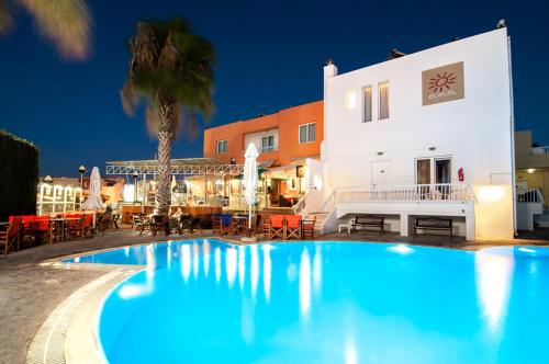 a large swimming pool in front of a building at Valsami Hotel Apartments in Kremasti