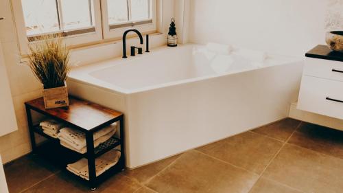 a large white tub in a kitchen with a sink at Hotel garni Seeluft Büsum in Büsum