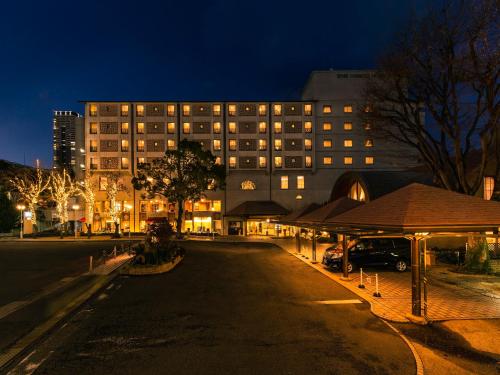 a building at night with a street in front of it at Senri Hankyu Hotel Osaka in Toyonaka