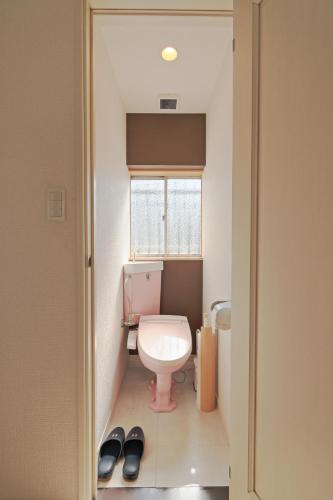 a small bathroom with a toilet and a window at V.Close to Nishi-Shinjuku/FrWIF/ Roof top Terrace in Tokyo