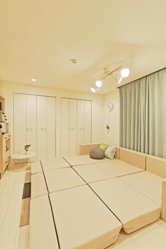 a room with four beds in a room at V.Close to Nishi-Shinjuku/FrWIF/ Roof top Terrace in Tokyo