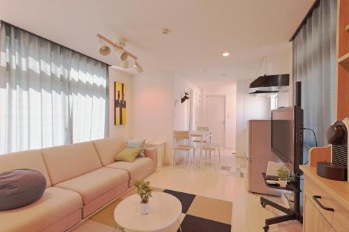 a living room with a couch and a tv at V.Close to Nishi-Shinjuku/FrWIF/ Roof top Terrace in Tokyo