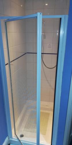 a shower with a glass door in a bathroom at Northdene Theatre Hotel in Blackpool