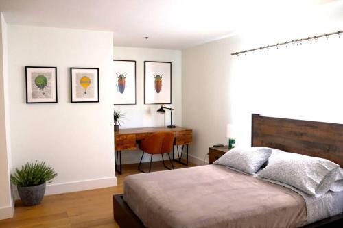 a bedroom with a bed and a desk at HEART OF WEST HOLLYWOOD MODERN SUITE 2 BEDROOM 2 BATH in Los Angeles