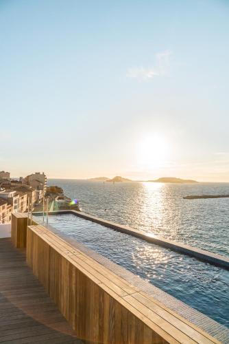 a swimming pool on a pier next to the water at Les Bords De Mer in Marseille