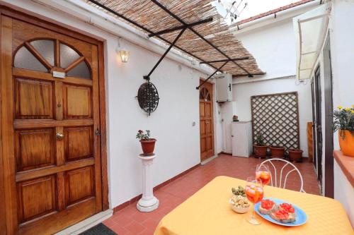 a room with a table and a wooden door at Sorrento Amore Mio in Sorrento