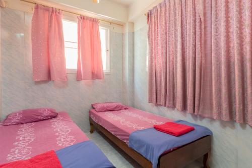 A bed or beds in a room at New Central Guesthouse