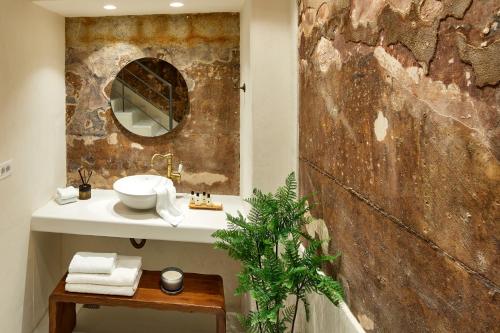 a bathroom with a sink and a mirror at Winery Hotel 1870 in Fira