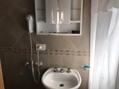 a bathroom with a sink and a shower at La sacha sin fin in Merlo