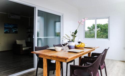a dining room with a wooden table and chairs at Tablas Seaview Homestay in Ferrol