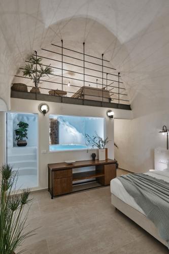 a bedroom with a large fish tank on the wall at Winery Hotel 1870 in Fira