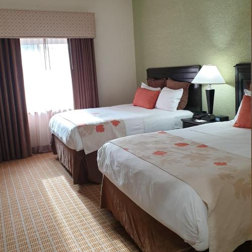 Letto o letti in una camera di Hawthorn Extended Stay by Wyndham Kingsland