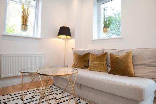 a living room with a couch and two tables at Sunshine Place in Enfield