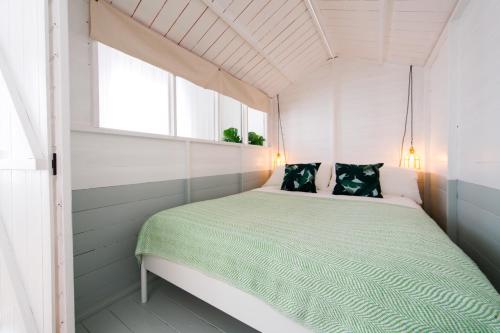 a bed in a small room with a window at The Log Cabin in Holborn, by the Design Traveller in London
