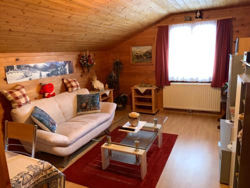 a living room with a couch and a table at Hotel Haus Mühlebach in Ernen