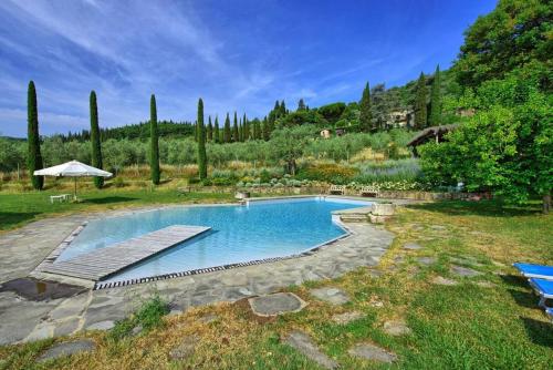 a swimming pool in a yard with trees at Agriturismo Fattoria Celle in Figline Valdarno