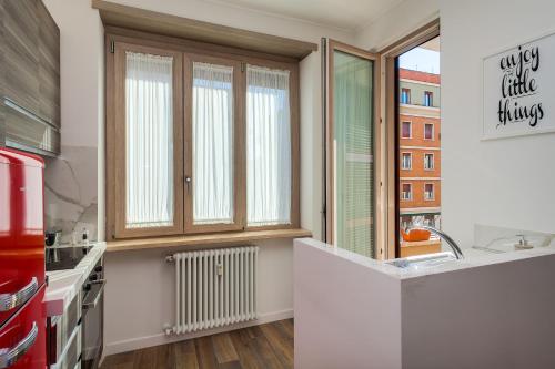a kitchen with a sink and a window at Many Days Apartments in Rome