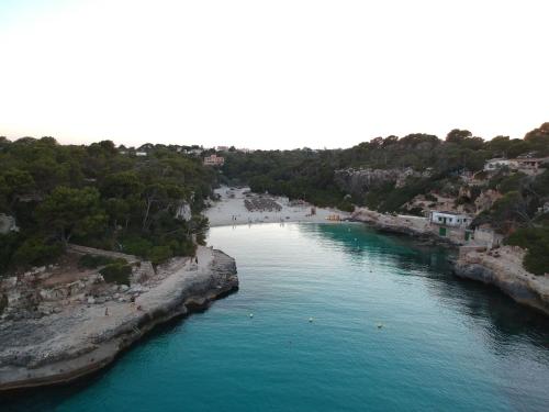 an aerial view of a river with a beach at Ca n'Alorda Holiday Home Cala Llombards piscina, wifi, seguridad y relax in Santanyi