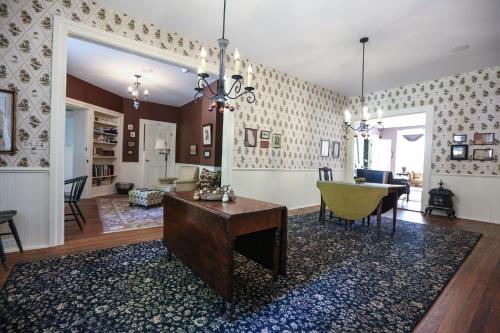 a living room with a table and a dining room at Black Sheep Inn and Spa in Hammondsport