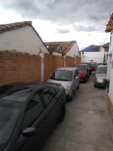 a row of cars parked in a parking lot at Hotel El Peregrino De La Villa in Villa de Leyva