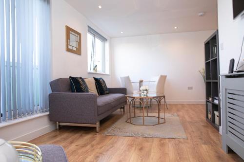 a living room with a couch and a table at Sunshine Place in Enfield