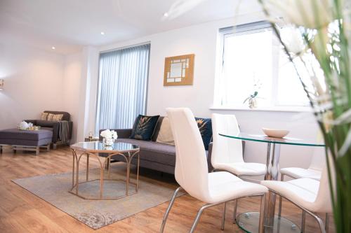 a living room with a couch and a table at Sunshine Place in Enfield